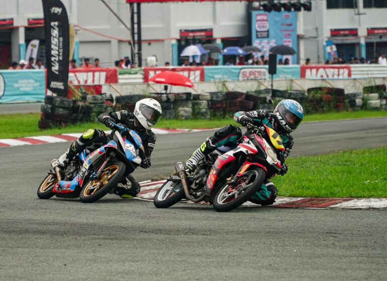 Exciting motorcycle race with skilled riders taking sharp turns on a track in Tarlac City, Philippines.